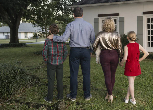 Ashley with her family outside their Baton Rouge home